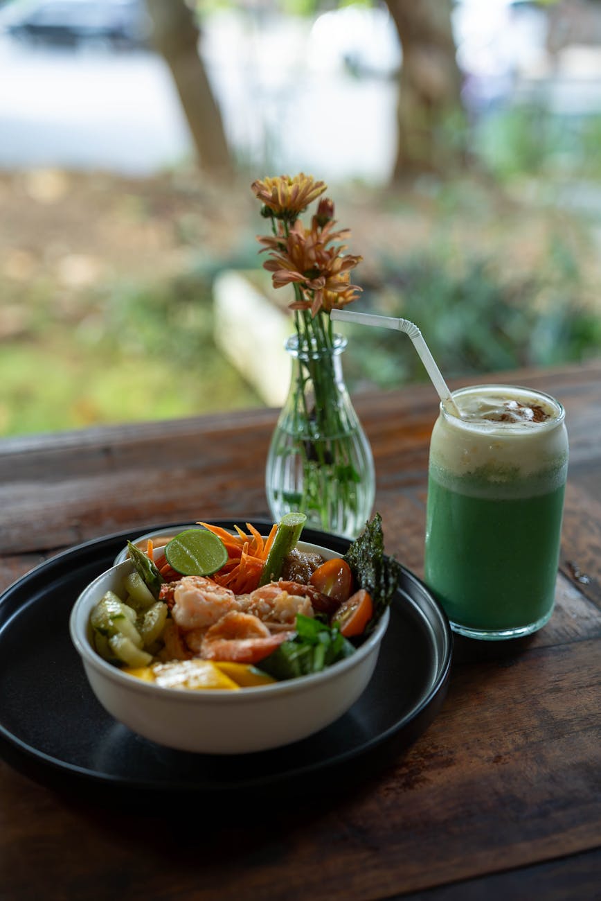 fresh salad and vegetable juice on wooden table
